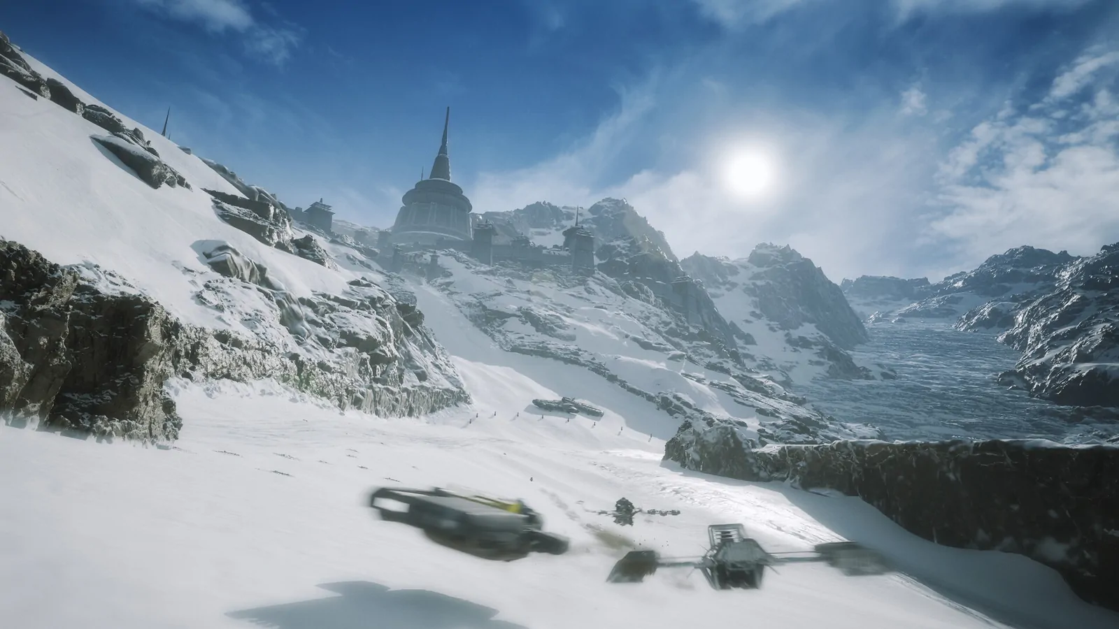 Wide vista of a snow-covered racing environment with distant spires under a bright sun